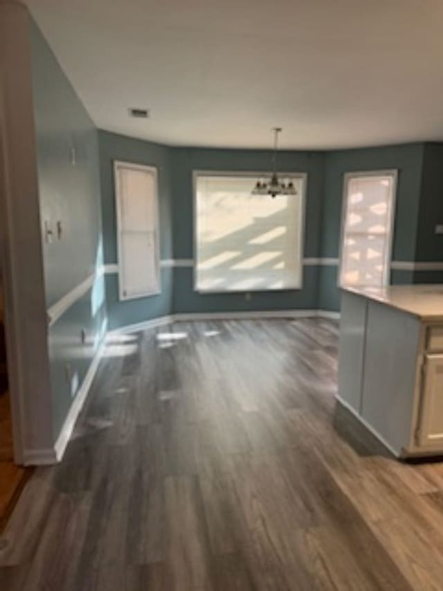 unfurnished living room with dark hardwood / wood-style floors