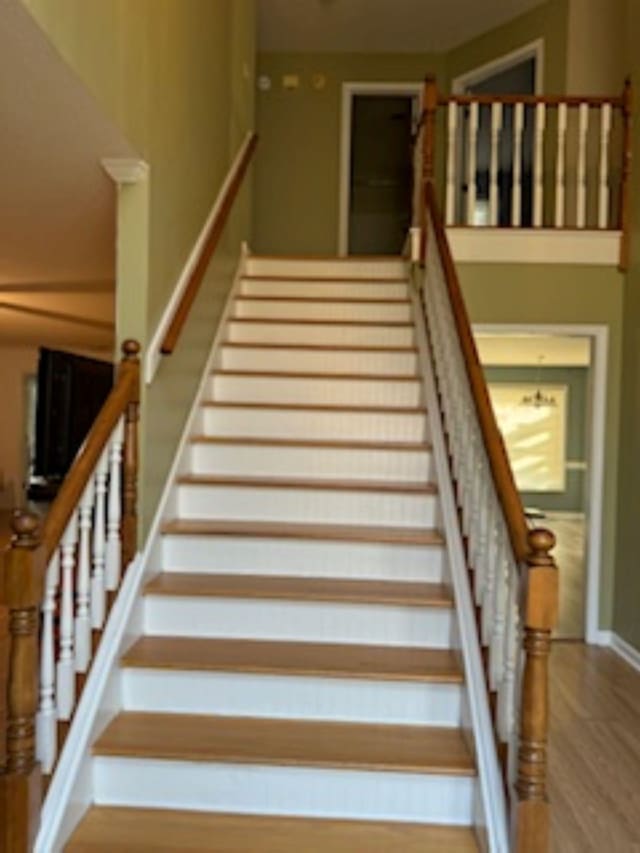 staircase with hardwood / wood-style floors