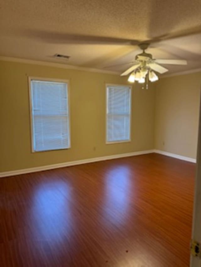 7565 Wintergreen Ln NW, Tn, TN 38018 - empty room featuring baseboards, ornamental molding, a textured ceiling, a ceiling fan, and wood finished floors