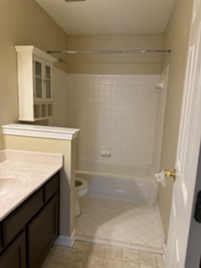 full bathroom featuring tile patterned flooring, vanity, toilet, and  shower combination