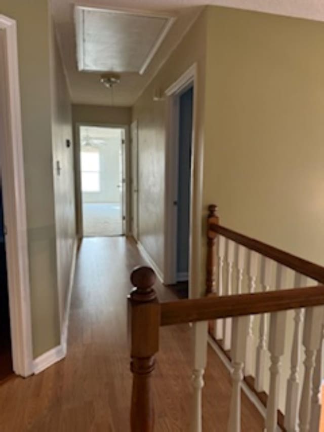 7565 Wintergreen Ln NW, Tn, TN 38018 - hall featuring baseboards, an upstairs landing, attic access, and wood finished floors