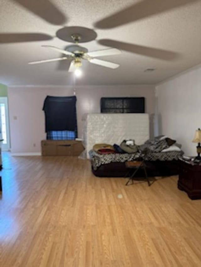 living room with ceiling fan and light hardwood / wood-style flooring