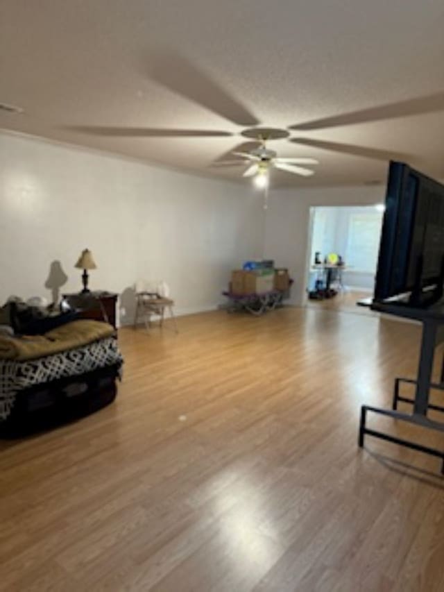 interior space featuring wood-type flooring and ceiling fan