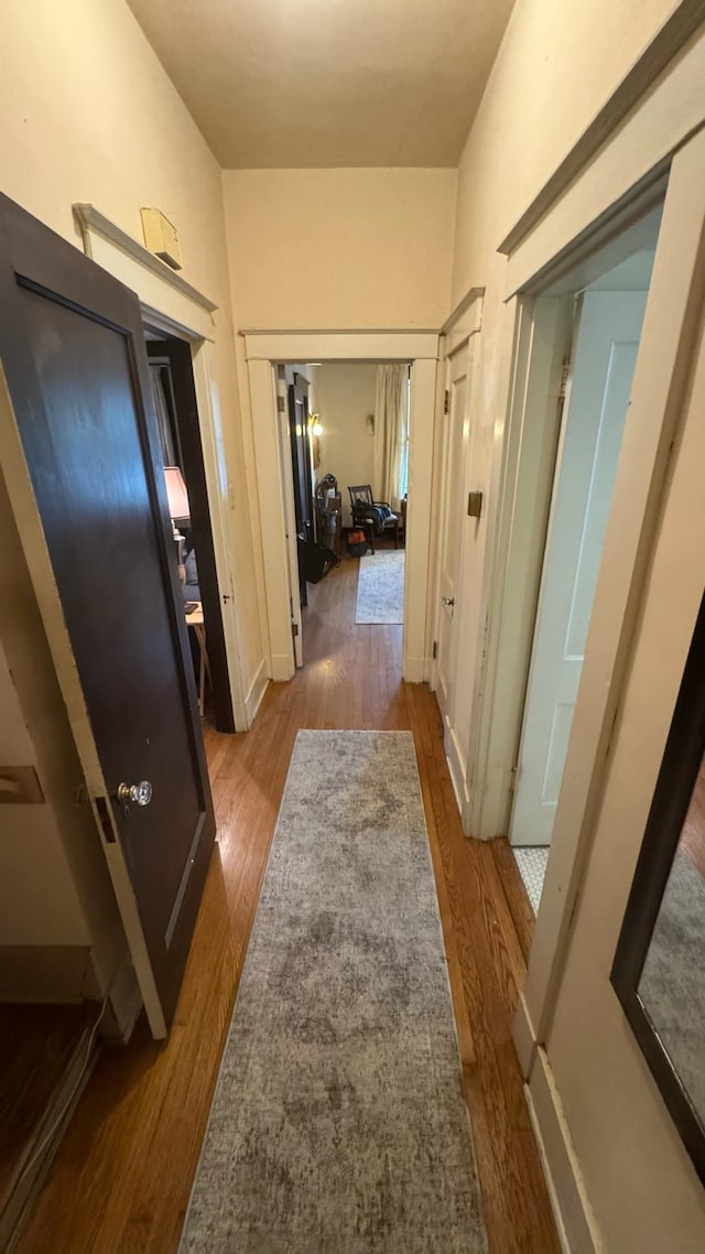 corridor with wood-type flooring