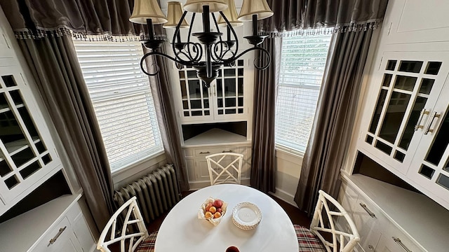 dining room featuring radiator and a chandelier