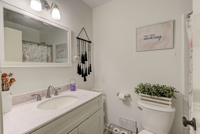 bathroom with vanity and toilet