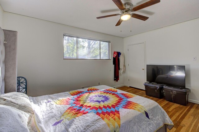 bedroom featuring ceiling fan and wood-type flooring