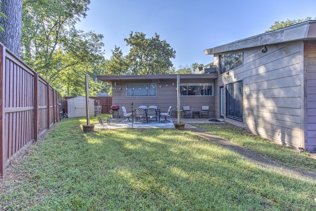 view of yard featuring a patio and a storage unit