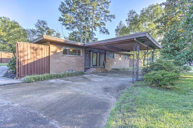 view of front of house with a front lawn and a carport