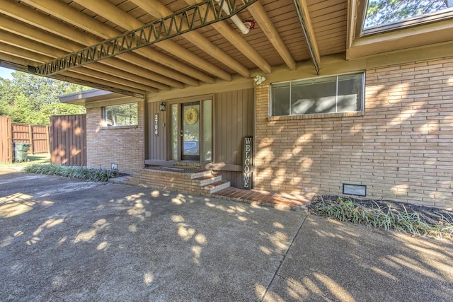 view of exterior entry featuring a patio