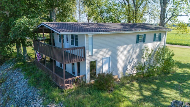 view of side of home with a yard