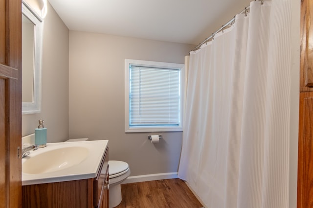 bathroom featuring walk in shower, vanity, toilet, and hardwood / wood-style flooring