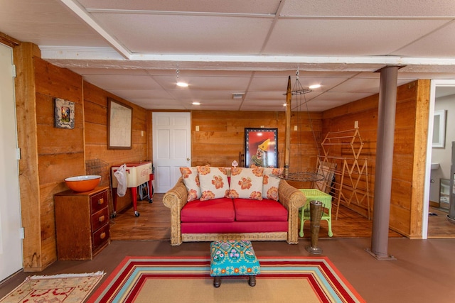 living area with wood walls and recessed lighting