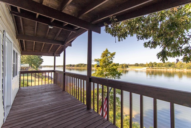 wooden terrace featuring a water view