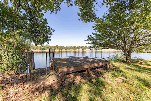 view of yard with a boat dock and a water view
