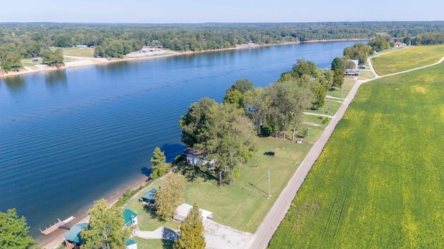 bird's eye view featuring a wooded view and a water view