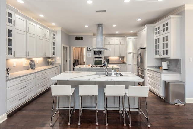 kitchen with white cabinetry, dark hardwood / wood-style flooring, range hood, and an island with sink