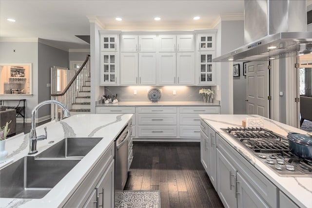 kitchen with white cabinets, sink, dark wood-type flooring, and wall chimney range hood