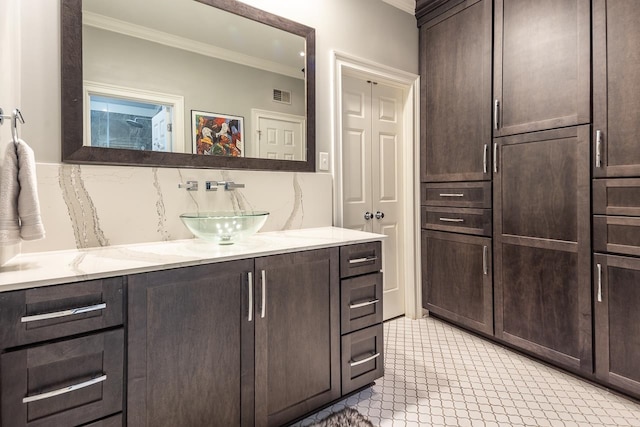 bathroom with ornamental molding, backsplash, and vanity