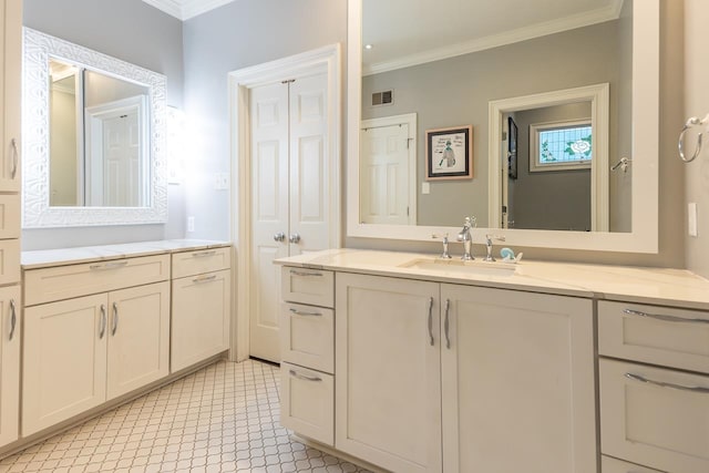 bathroom with crown molding and vanity