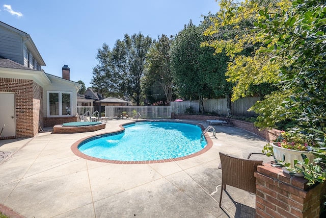 view of swimming pool with a patio and a jacuzzi