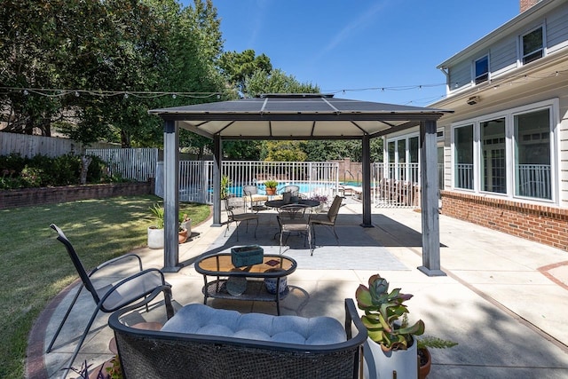 view of patio / terrace featuring a gazebo, an outdoor living space with a fire pit, and a fenced in pool