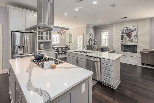 kitchen featuring a spacious island, appliances with stainless steel finishes, plenty of natural light, and island range hood