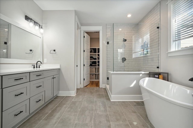 bathroom with independent shower and bath, vanity, and tile patterned floors