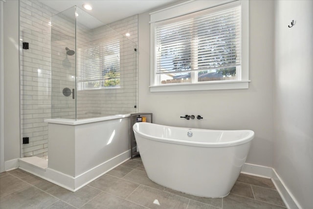 bathroom with separate shower and tub and tile patterned floors