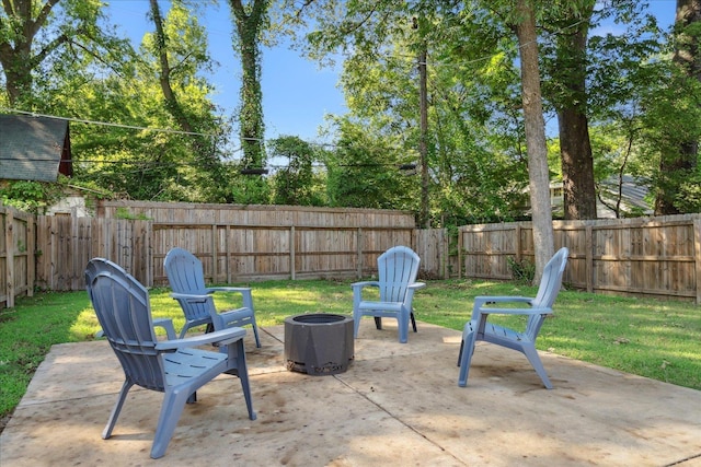 view of patio featuring a fenced backyard and an outdoor fire pit