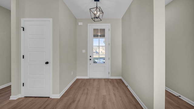 entryway featuring a chandelier and light hardwood / wood-style floors