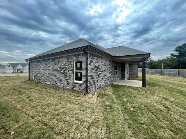 view of property exterior with a patio area and a yard