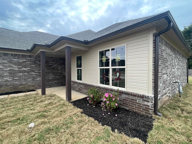 view of home's exterior featuring a lawn and a patio