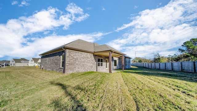 rear view of property with a yard