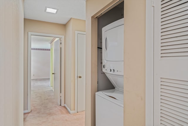 4781 Audubon View Cir Unit 2, Memphis, TN 38117 - laundry area featuring stacked washer / drying machine and light carpet