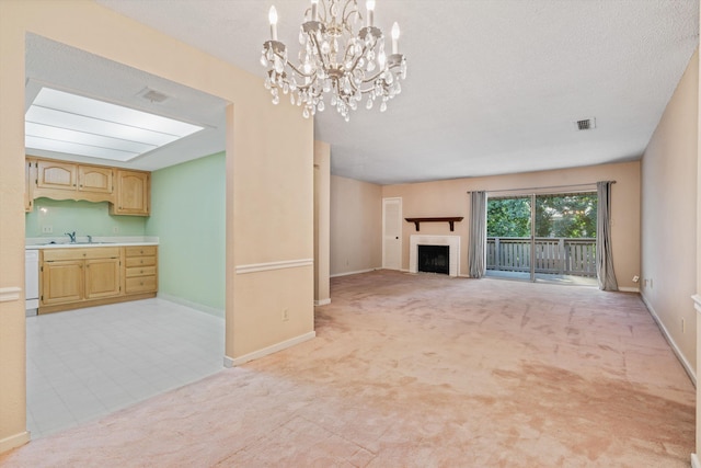 4781 Audubon View Cir Unit 2, Memphis, TN 38117 - unfurnished living room with light colored carpet, a fireplace, and a chandelier