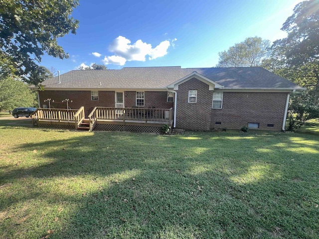 rear view of house featuring a yard and a wooden deck