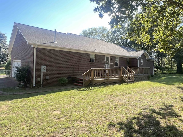 rear view of house with a deck and a lawn