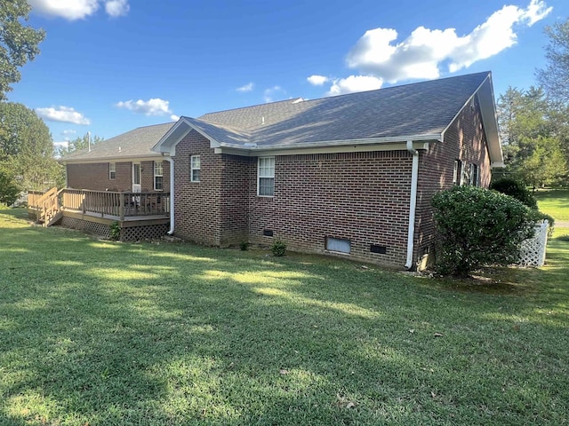 rear view of house featuring a yard and a wooden deck