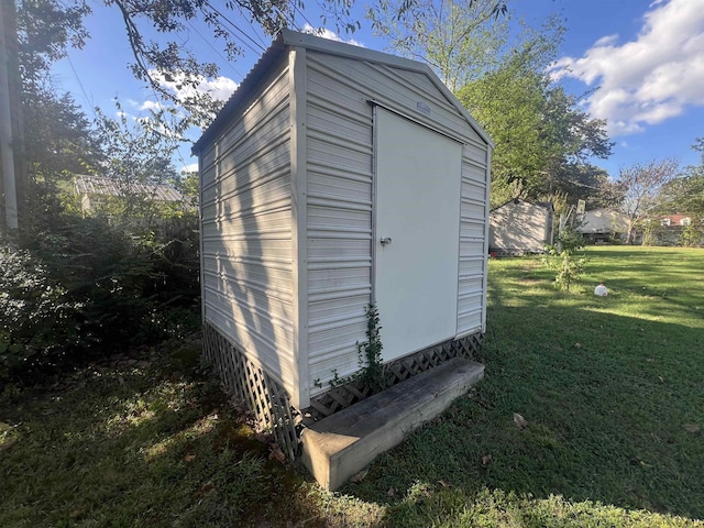 view of outbuilding featuring a yard