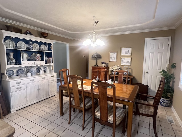 tiled dining room featuring a notable chandelier, ornamental molding, and a textured ceiling