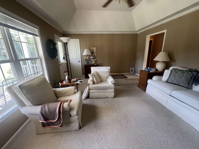 carpeted living room featuring ornamental molding, lofted ceiling, and ceiling fan