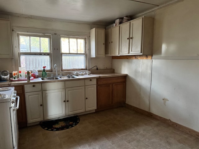 kitchen featuring white range oven and sink