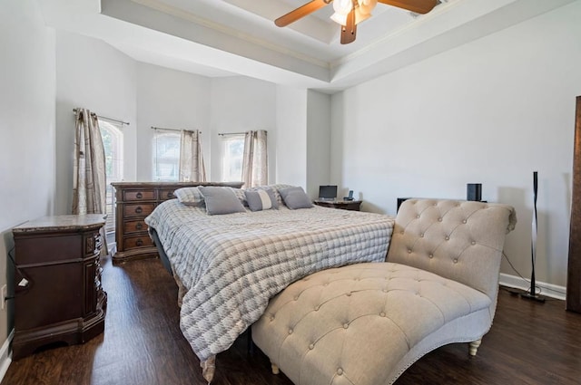 bedroom featuring ornamental molding, ceiling fan, a raised ceiling, and dark hardwood / wood-style floors