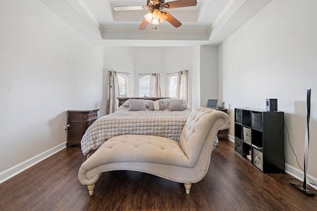 bedroom featuring ceiling fan, a tray ceiling, and dark hardwood / wood-style floors