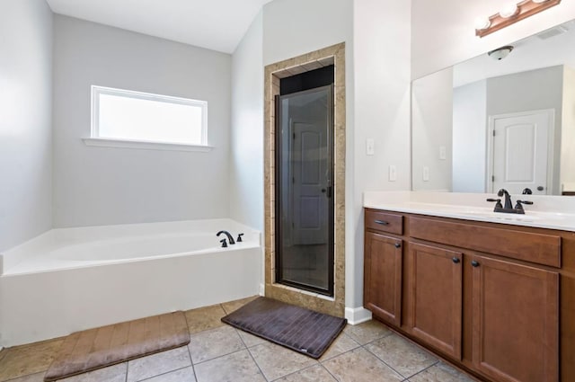 bathroom featuring independent shower and bath, vanity, and tile patterned floors