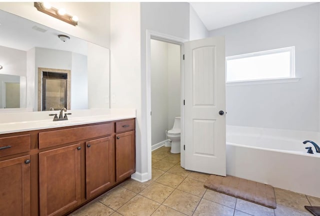 full bathroom featuring independent shower and bath, vanity, tile patterned flooring, and toilet