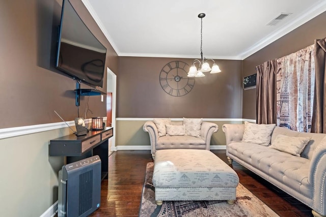 living room with ornamental molding, an inviting chandelier, and dark hardwood / wood-style flooring