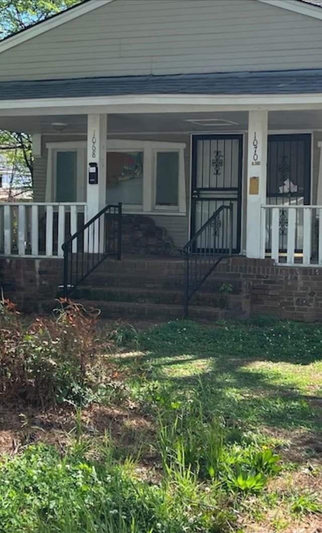 view of exterior entry featuring a porch