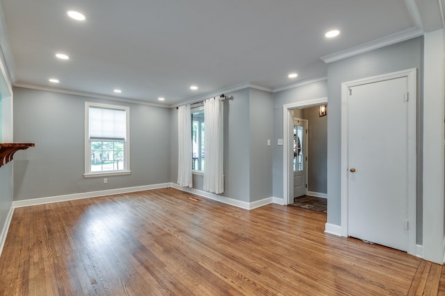 interior space with light hardwood / wood-style flooring and ornamental molding